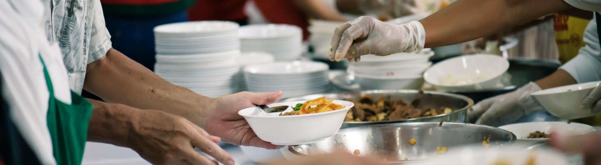 A close up of hands serving food