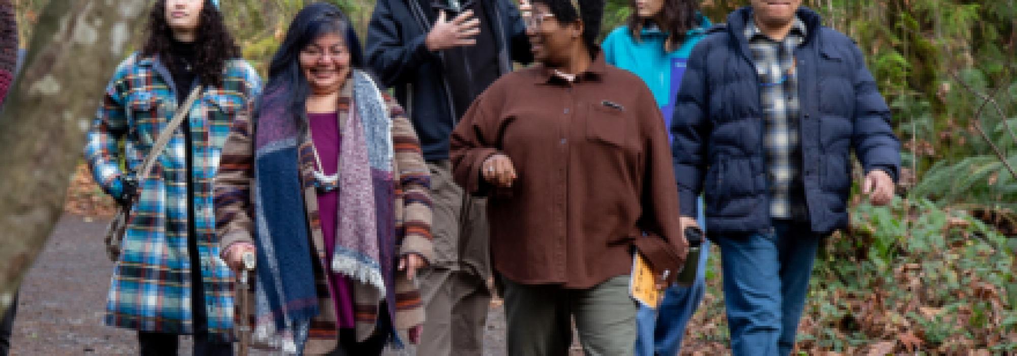 a group of people walking along a path talking